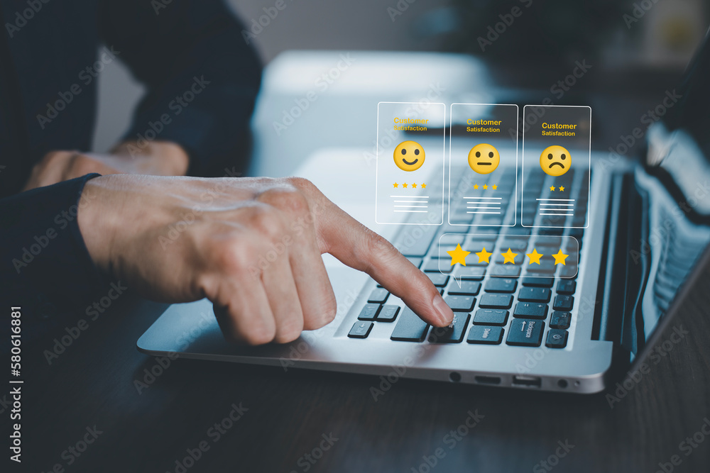 Businessman pressing smile on laptop keyboard customer service, evaluation concept,rating to service