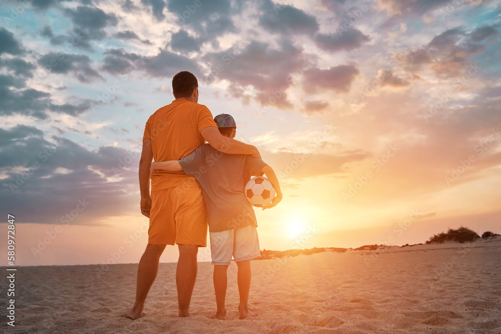 Happy family outdoors summer, Father and Son playing football, energy fun players in soccer in dynam