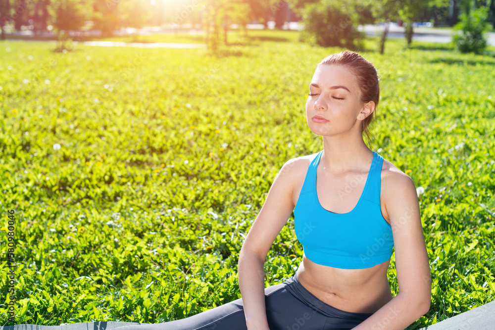 Smiling woman training outdoor at sunny day