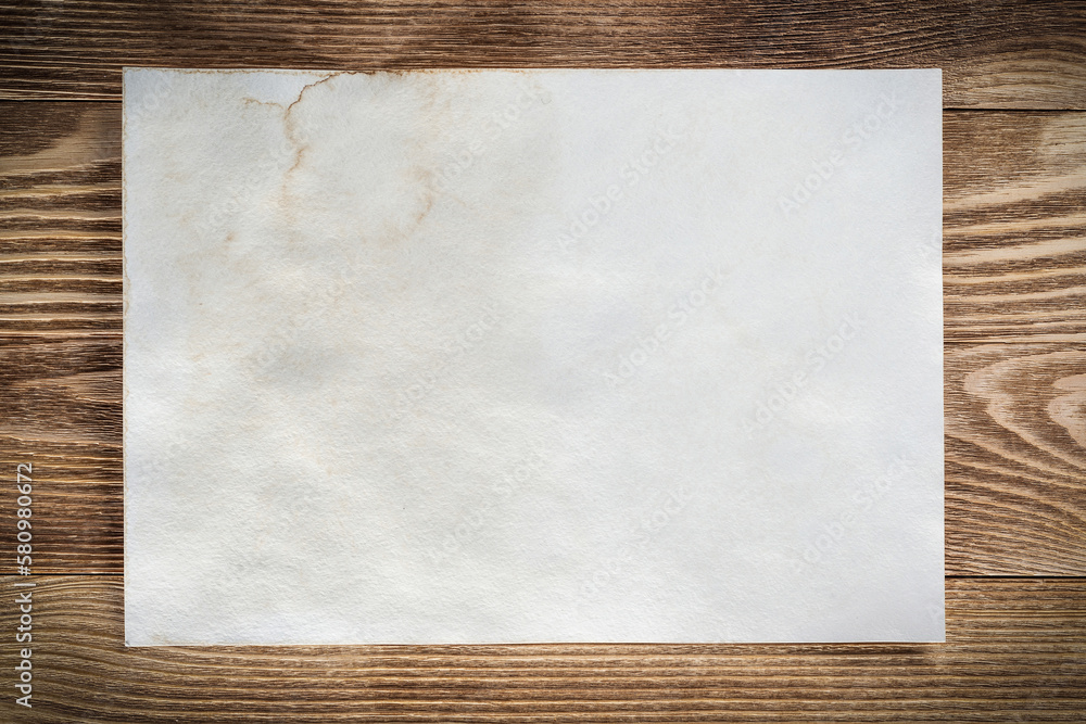 Sheet of paper lying on wooden table