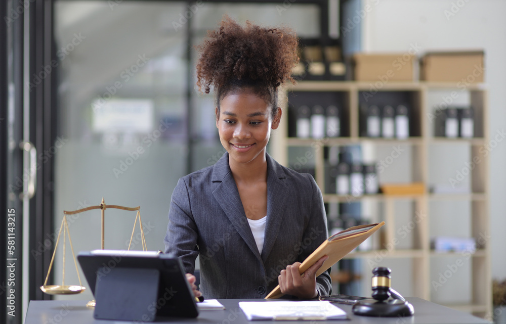 Female lawyer working on a desk in a law office.