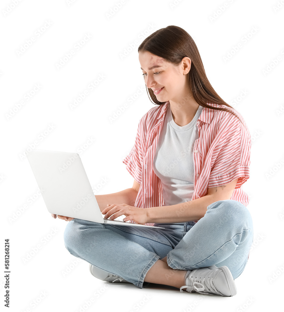 Sitting young woman with laptop isolated on white