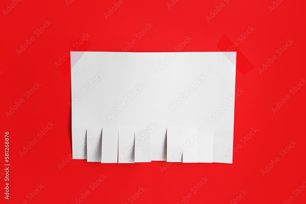 Blank paper tear-off ad on red background