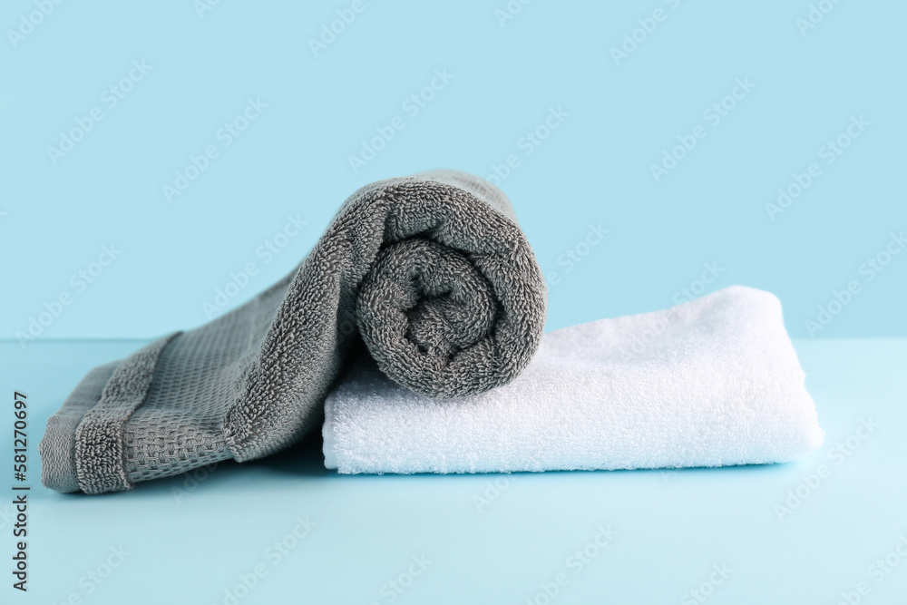 Clean soft towels on blue background