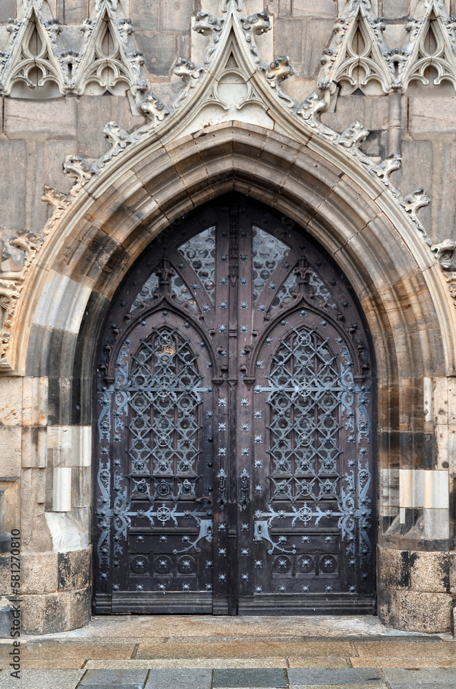 View of old Gothic building with metal door