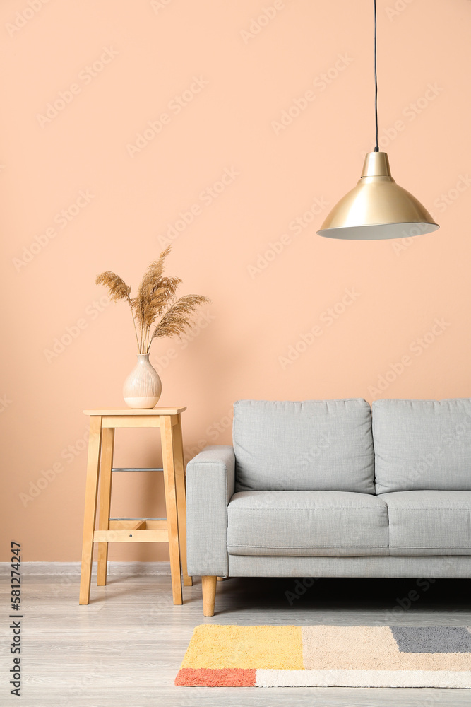 Interior of living room with grey couch and table