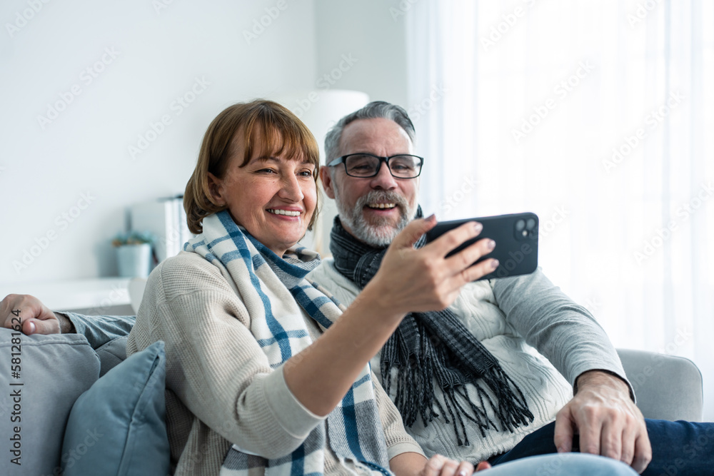 Caucasian senior couple video call with family in living room at home. 