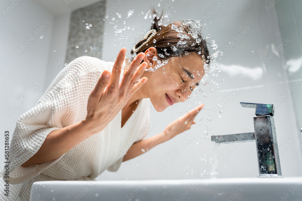 Asian beautiful woman washing her clean face with facial foam and water. 