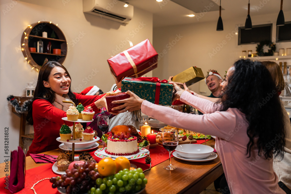 Multi-ethnic family exchanging presents during Christmas party at home. 