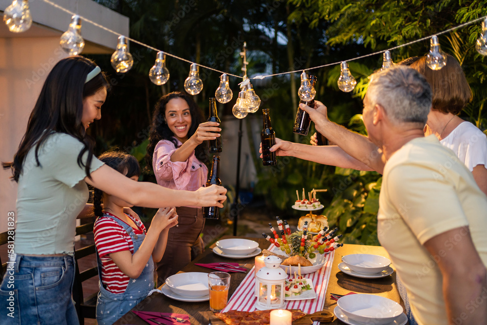 Multi-ethnic big family having fun, enjoy party outdoors in the garden. 