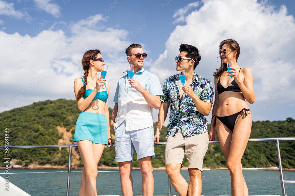 Group of diverse friends drink champagne while having a party in yacht. 