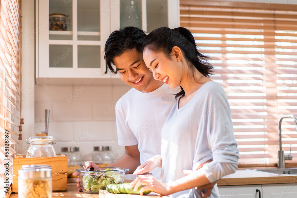 Asian young new marriage couple spend time together in kitchen at home.