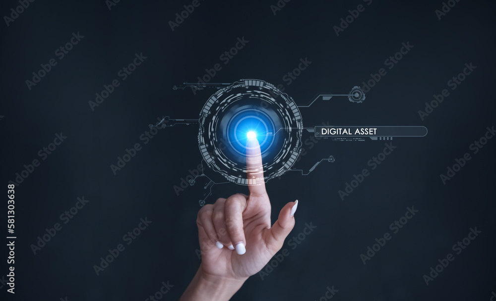 Finger touching some holographic graphic user interface with digital asset technology concepts.