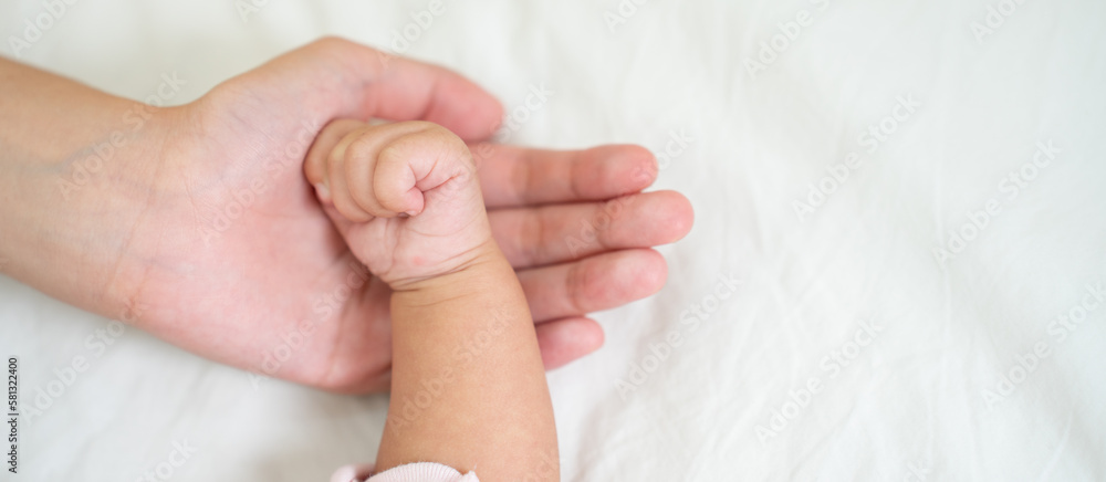 Asian Baby Hand in mothers hands that mean symblo of love. Mom and her Baby Child. Happy Family con