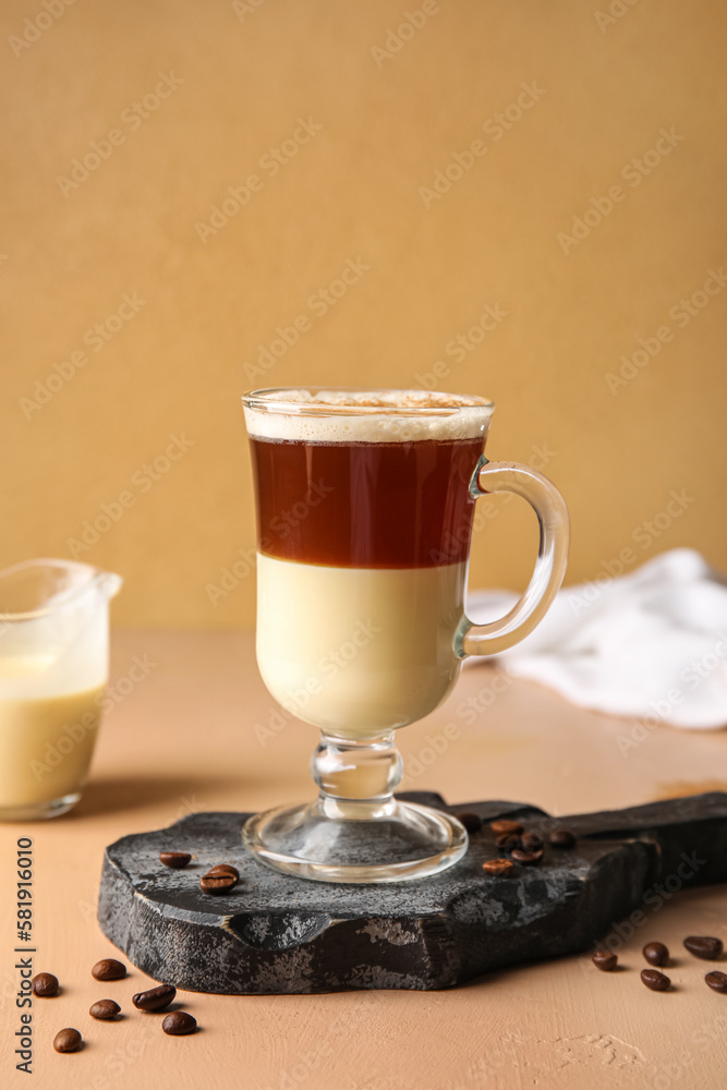 Board with glass of delicious Cafe Bombon on color background