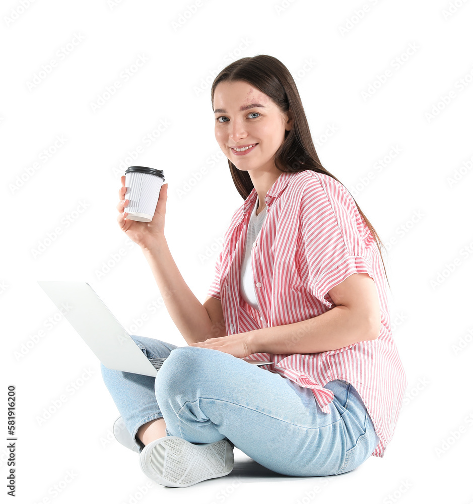 Sitting young woman with laptop and coffee isolated on white