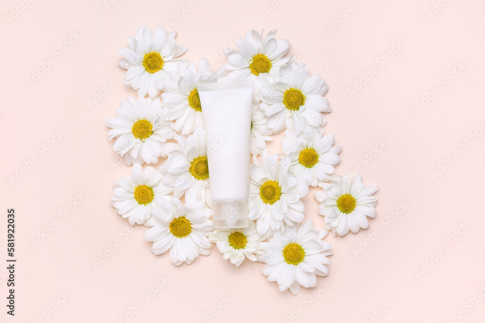 Composition with tube of cosmetic product and beautiful chamomile flowers on color background