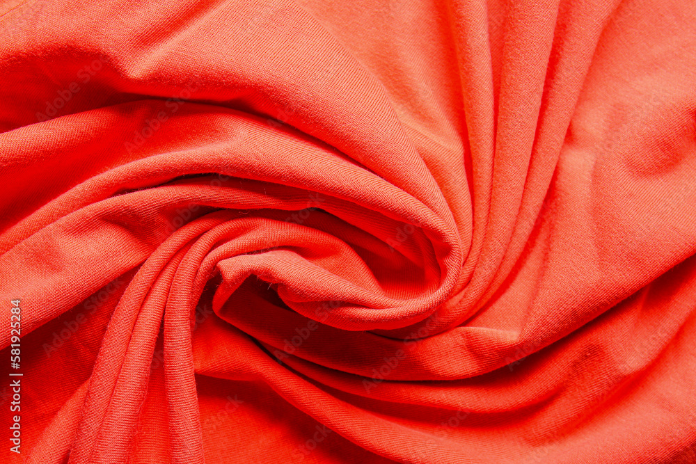 Closeup view of coral crumpled fabric texture as background