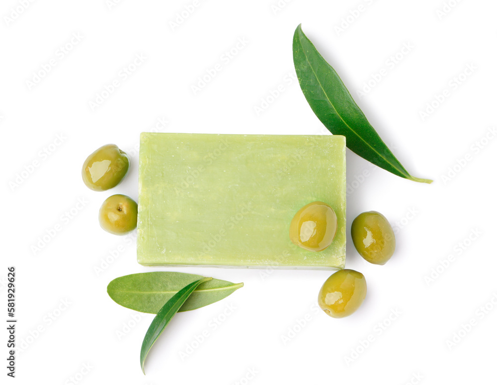 Natural soap bar, olives and plant leaves on white background