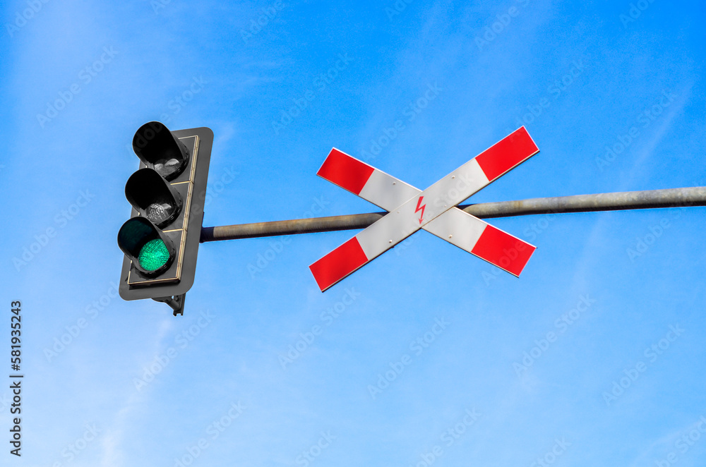 View of traffic light and sign against blue sky