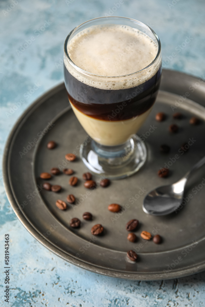 Plate with glass of delicious Cafe Bombon on color background, closeup