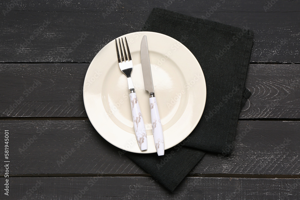 Table setting with napkin on dark wooden background