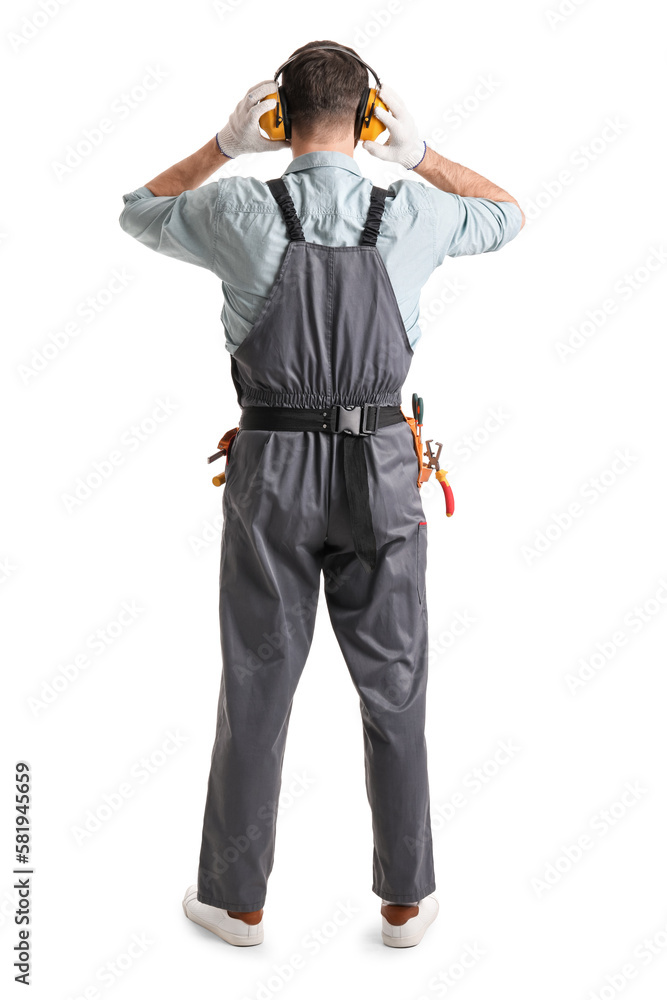 Male carpenter in hearing protectors on white background, back view