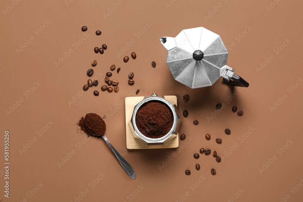 Coffee maker with powder and beans on brown background