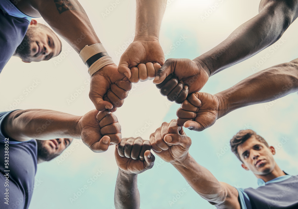 Hands, fist and solidarity with a sports team standing in a huddle for unity or motivation before a 