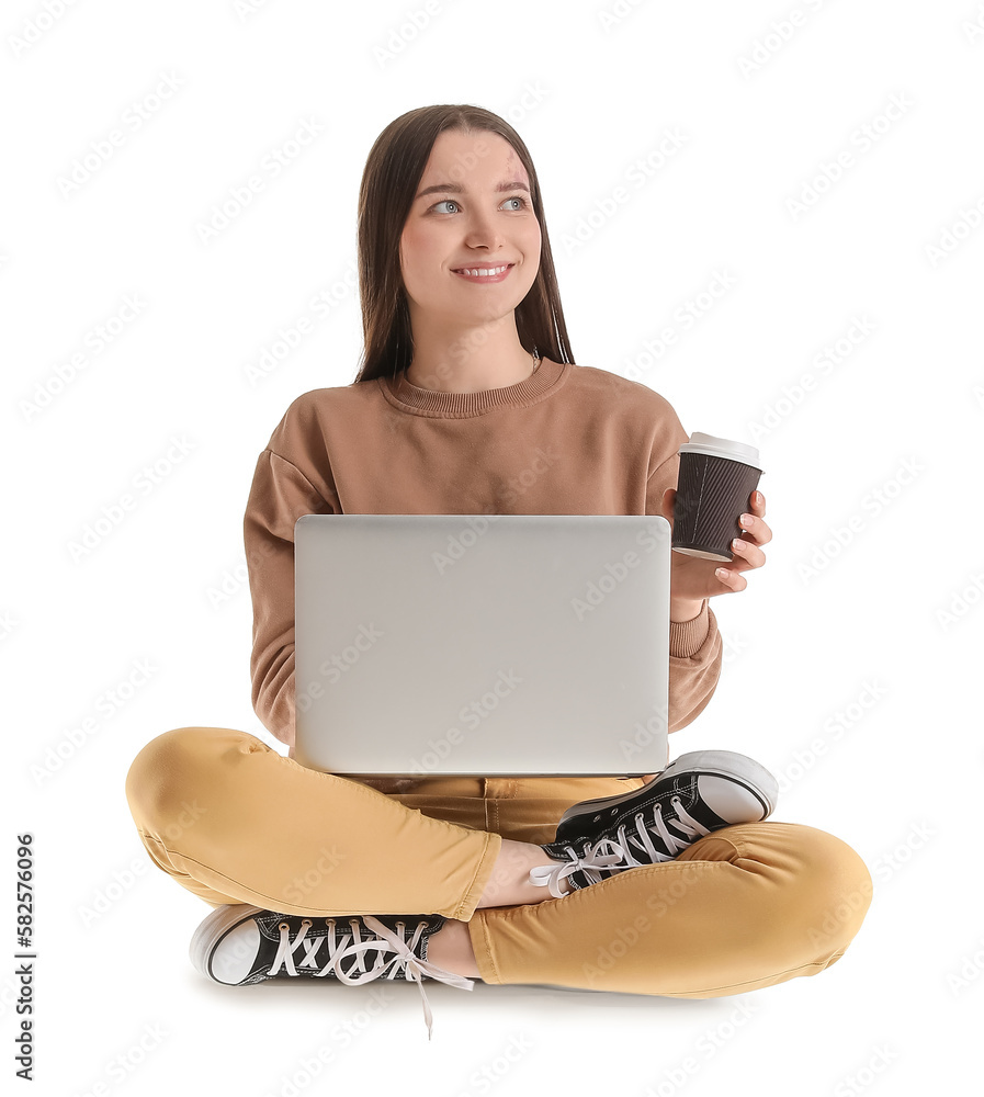 Pretty young woman with laptop and coffee sitting on chair against white background