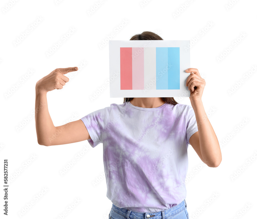 Young woman pointing at paint color palette on white background