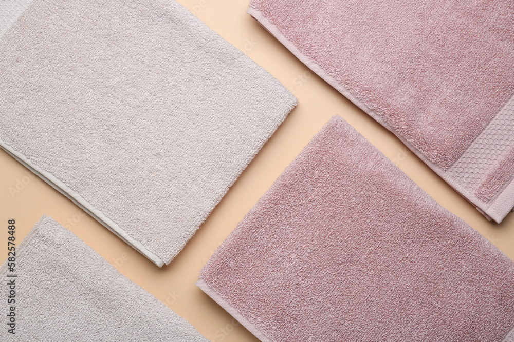 Folded soft towels on beige background