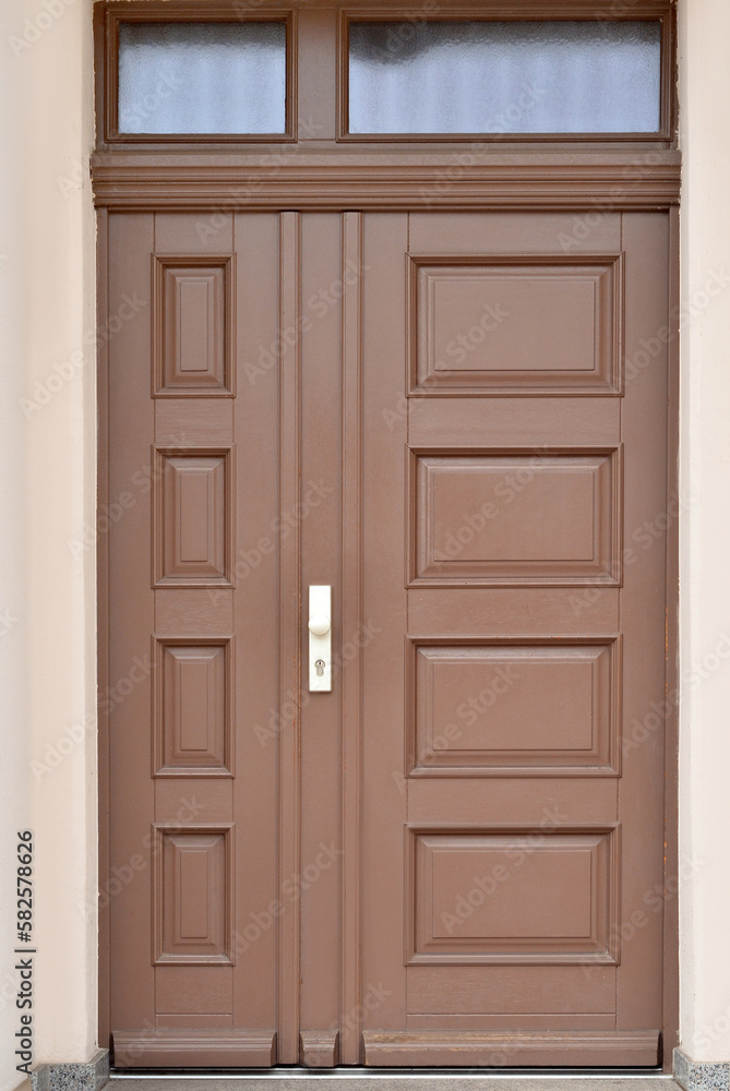 View of city building with wooden door