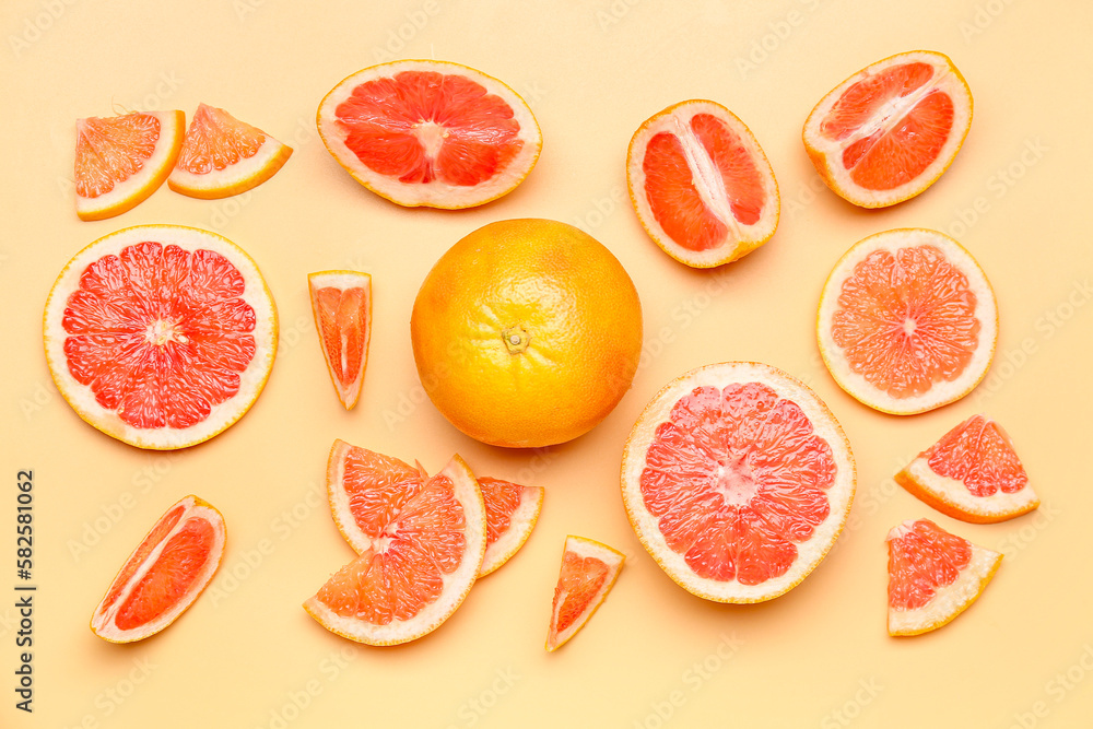 Composition with pieces of ripe grapefruit on color background