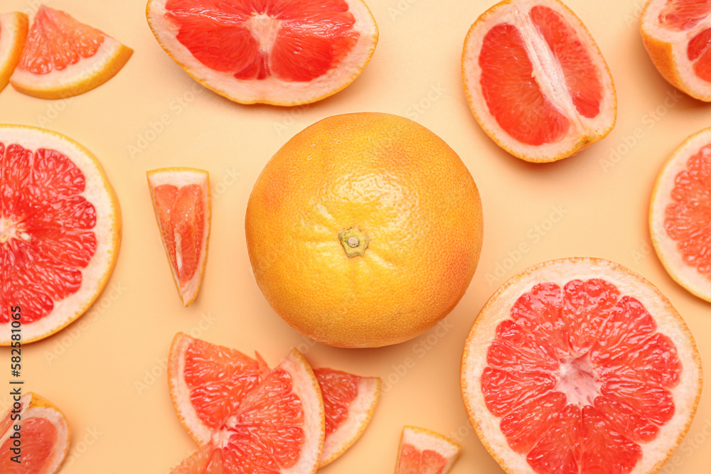 Composition with pieces of ripe grapefruit on color background