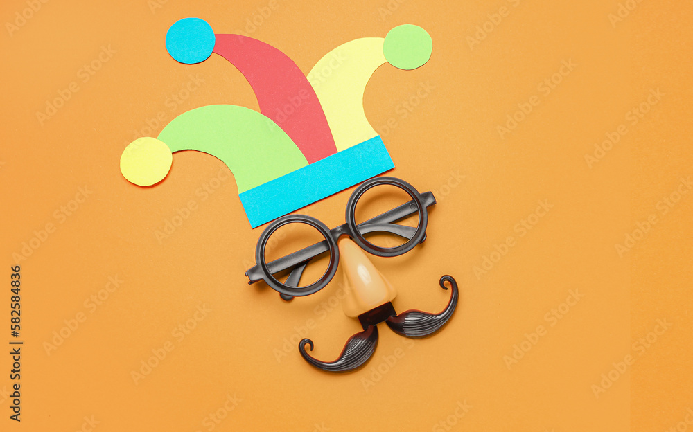 Paper fools hat with funny disguise on color background