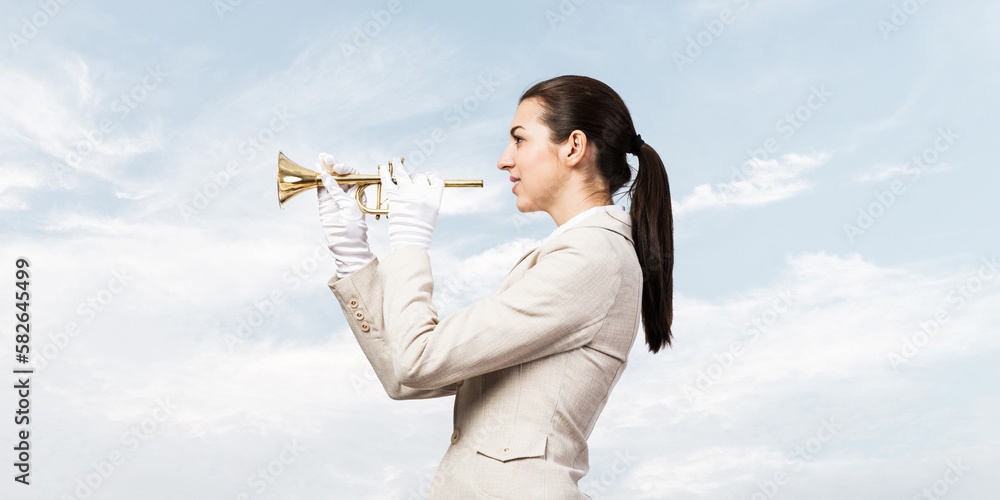 Beautiful woman playing trumpet brass