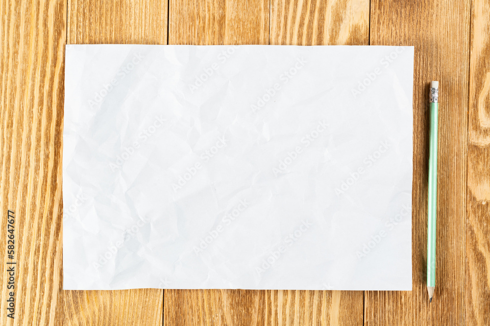 Sheet of paper lying on wooden table