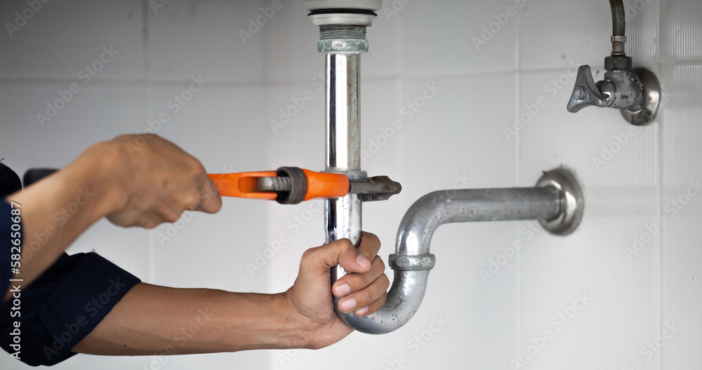 plumber at work in a bathroom, plumbing repair service, assemble and install concept.