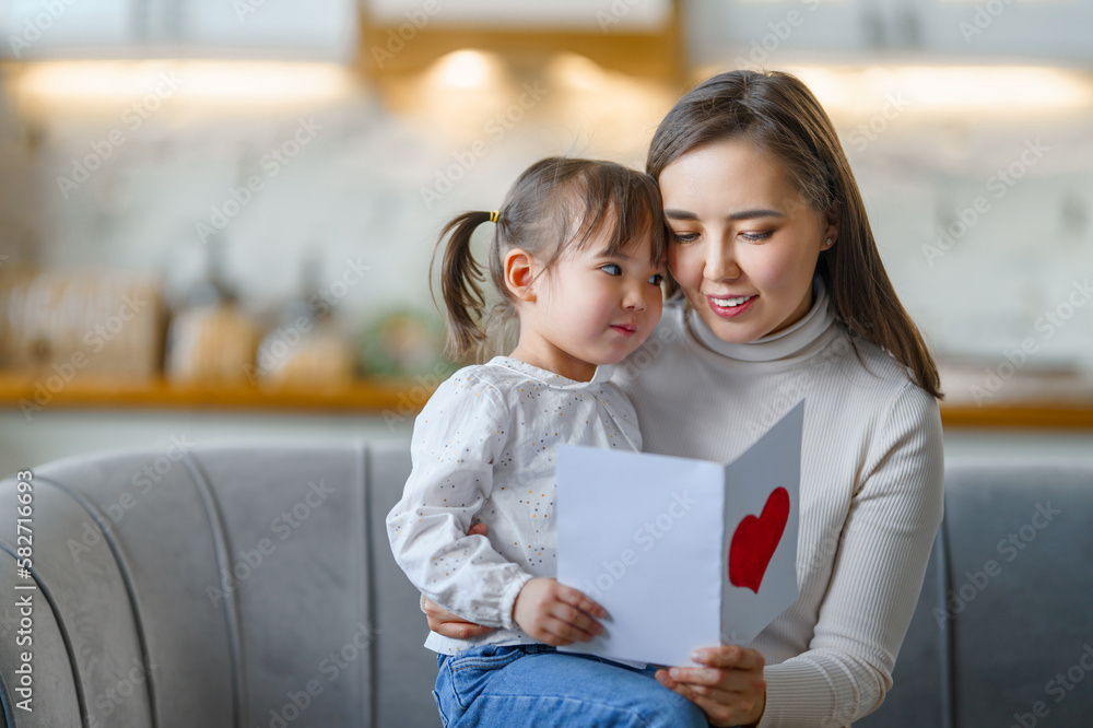 Daughter giving mother postcard