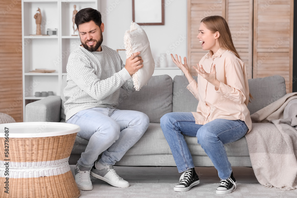 Young woman shouting at her husband in living room