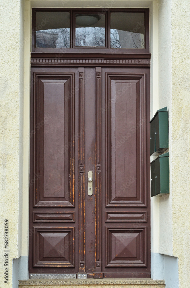 View of city building with old wooden door