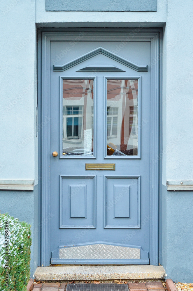 View of city building with grey wooden door