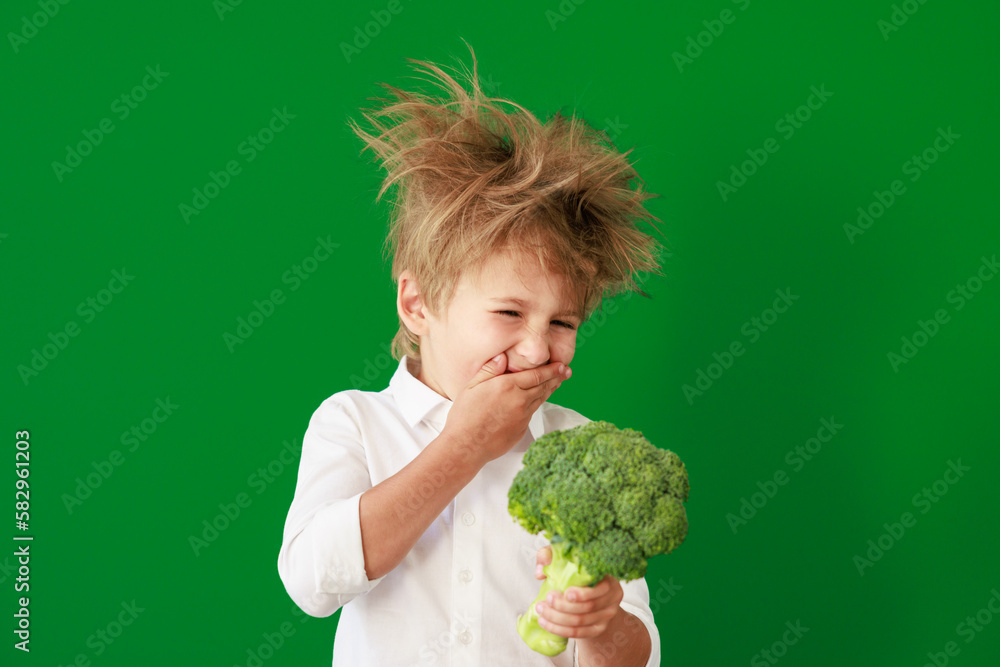 Surprised child against green chalkboard in class