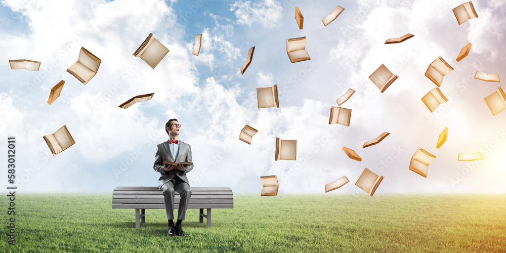 Young businessman or student studying the science and books fly around