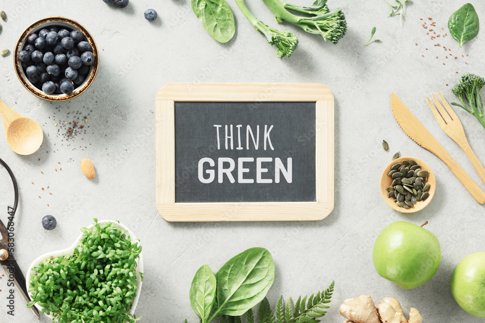 Vegetarian vegan healthy ingredients and think green chalk board on grey stone background