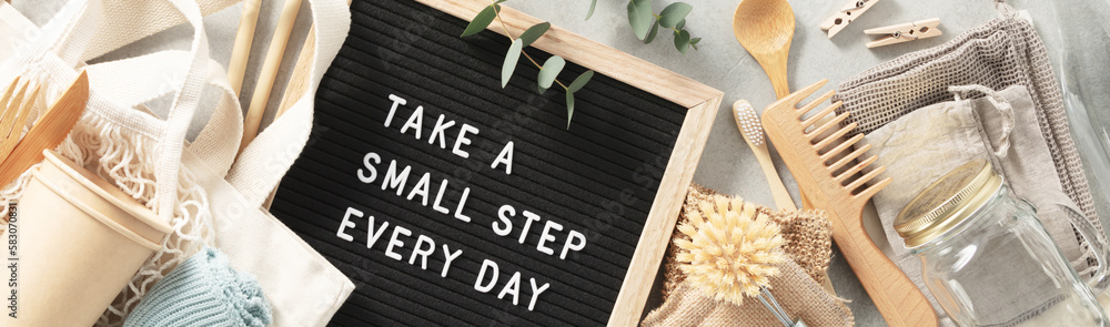 Take a small step every day letter board and zero waste no plastic accessories on grey stone backgro