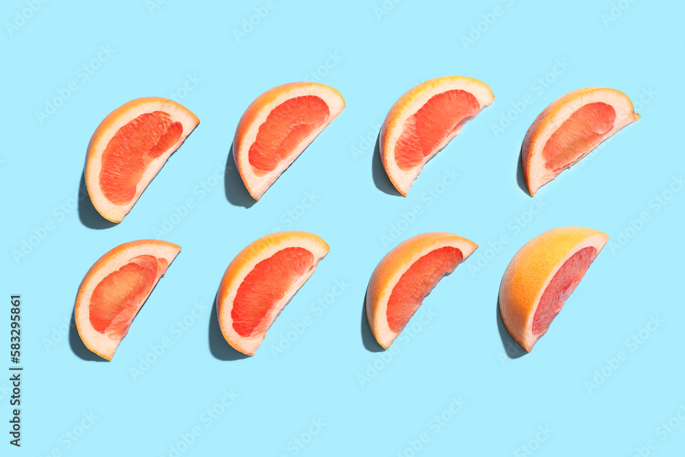 Composition with pieces of ripe grapefruit on color background