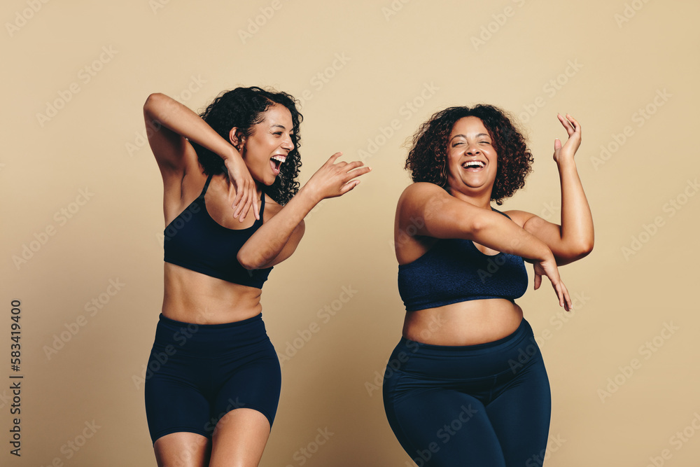 Youthful female friends enjoying a dance workout in a studio