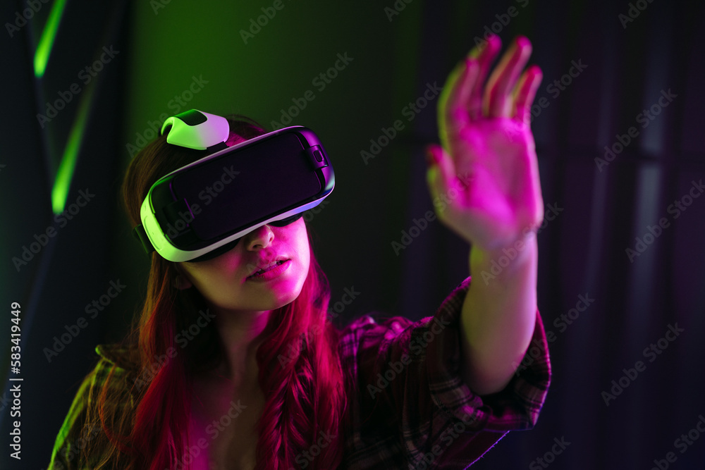 Woman interacting with virtual reality using a VR headset